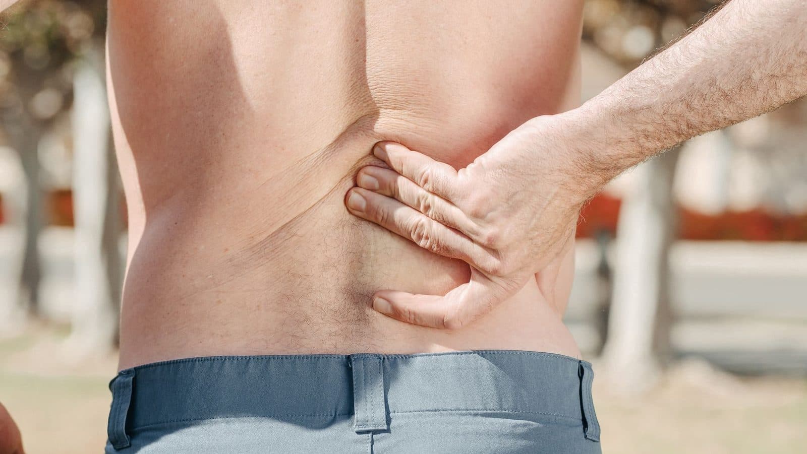 Man holding his lower back in pain